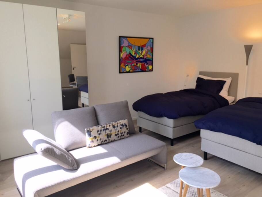 Twin room with Ensuite bathroom, lounge area and dining table for 4.
