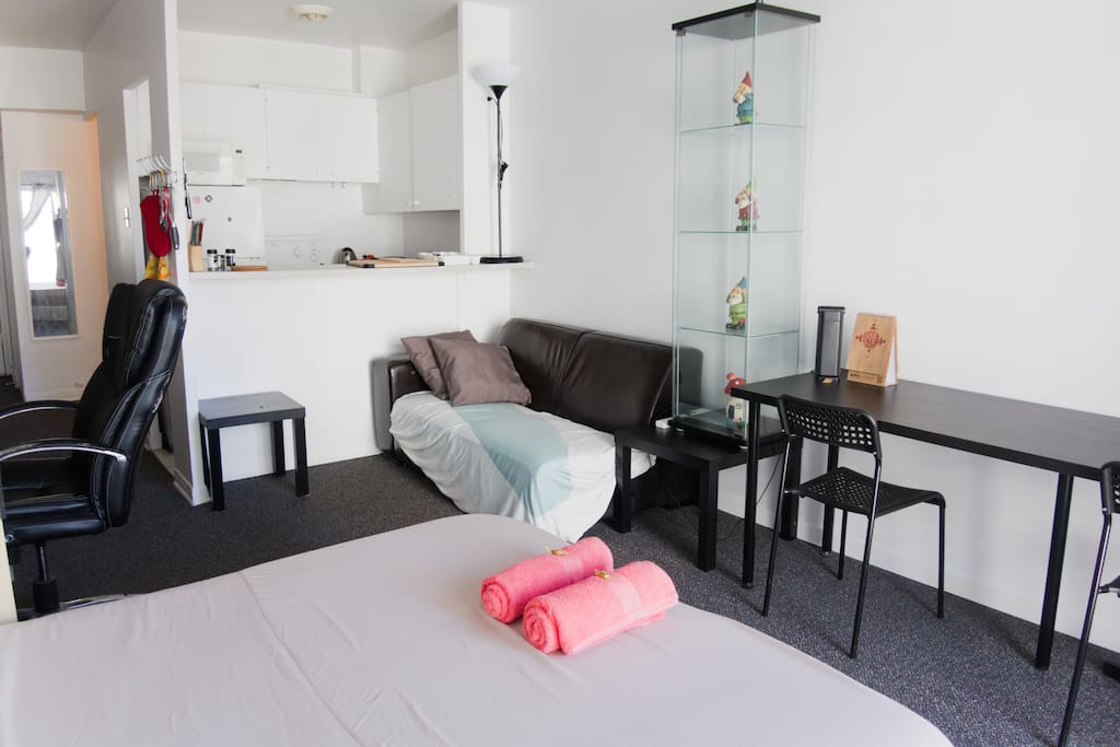 A large desk for work and a comfortable couch for lazing around on a rainy day
