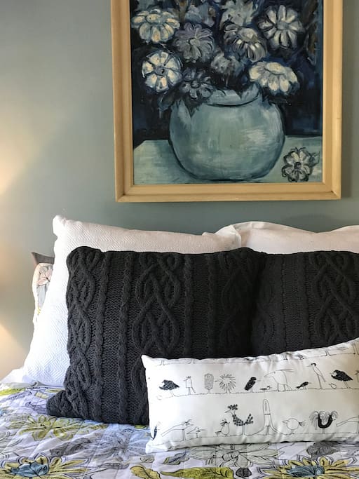 Queen bed covered with stateen sheets for coolness in the summer and thick warm blankets in the winter.