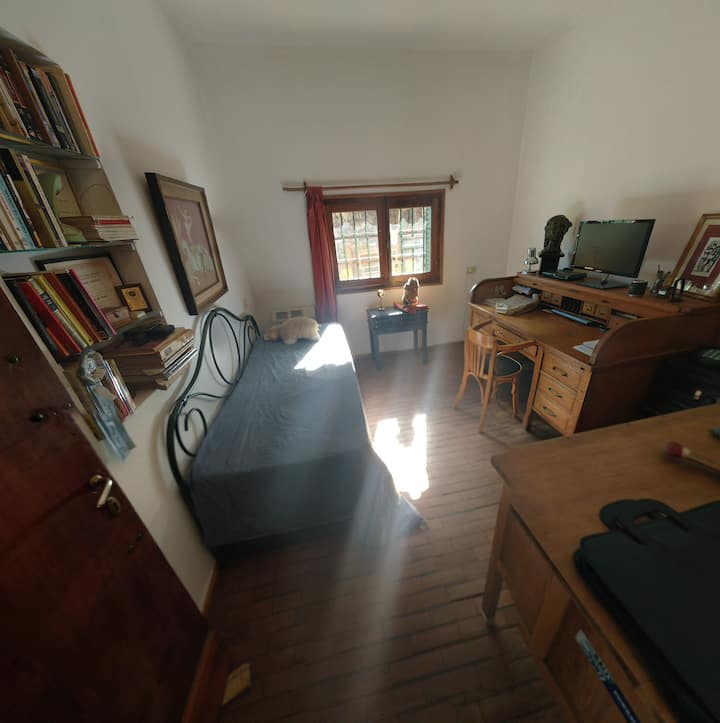 Studio / desk area with bed to be used as a bedroom, it has heating.