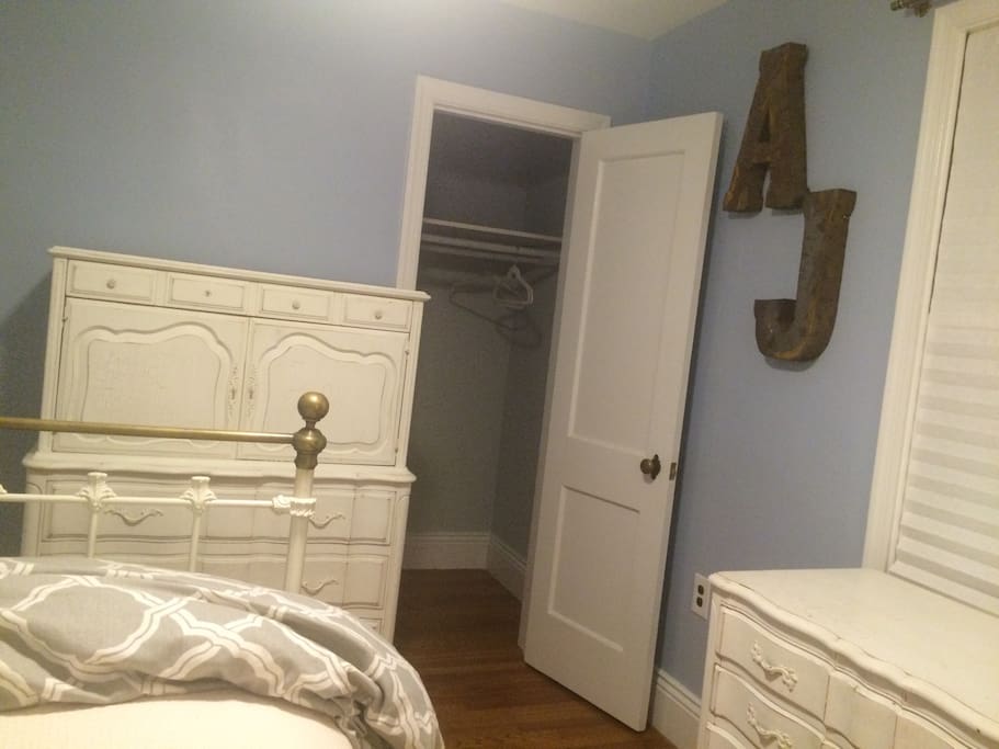 Deep closet with two hanging rods and two dressers