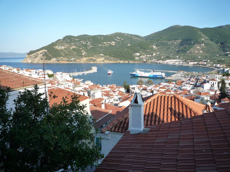 Panoramic views of the harbour, Skopelos bay and the islands beyond.