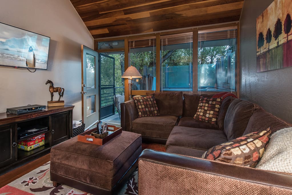 Living room with 50" wall mounted TV and comfortable sectional seating