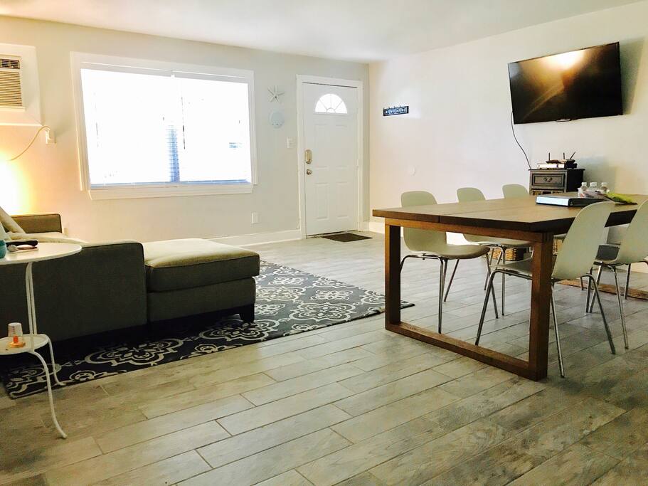 Living room and dining room combo with pull out couch and room for 6 at the table
