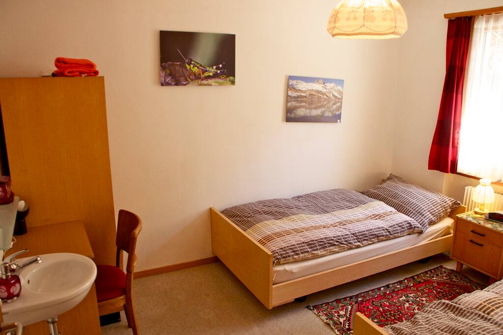 2 single bed room with wash basin.