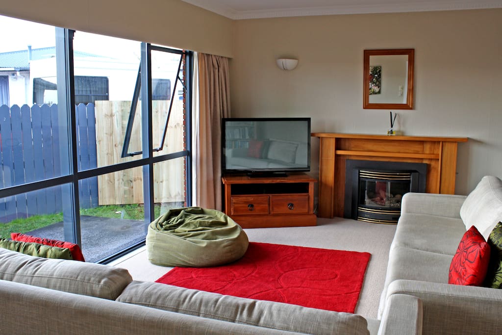 Living space to seat six people comfortably, also a bean bag chair and a TV