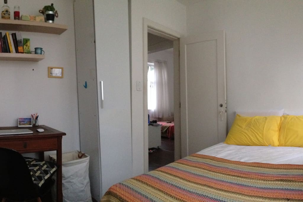 Room with spacious bed, desk and wardrobe
