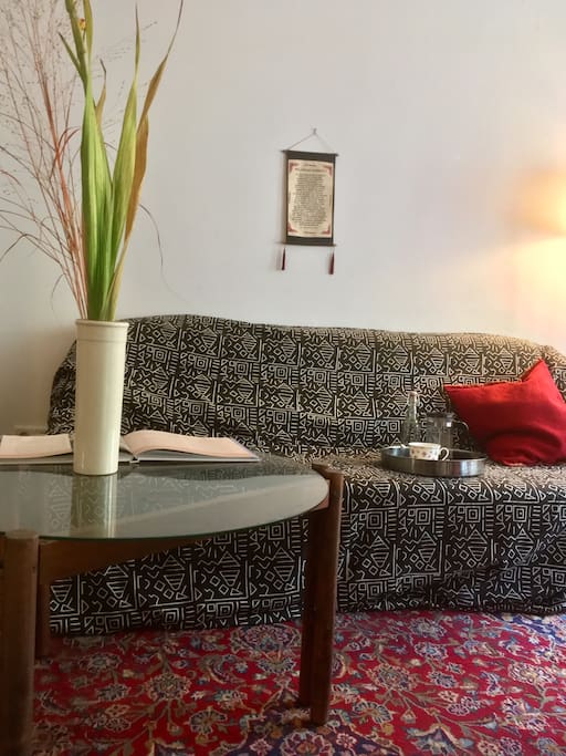 Sofa and coffeetable, huge persian carpet.