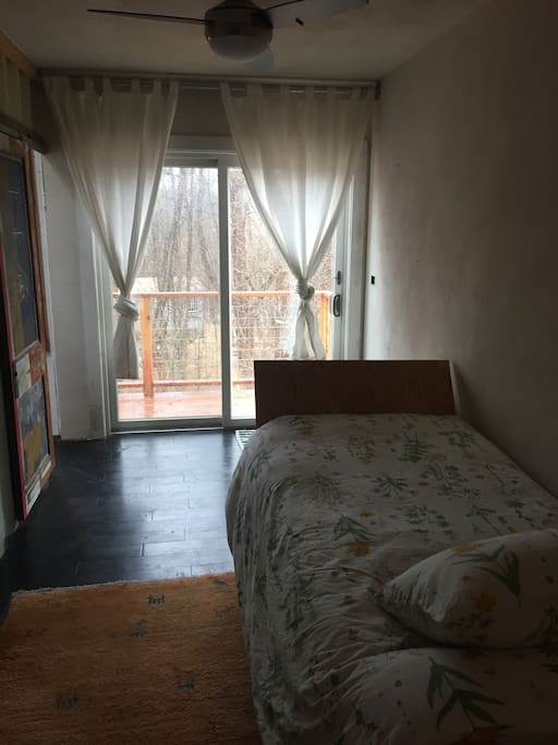 single bedroom with large balcony toward the forest