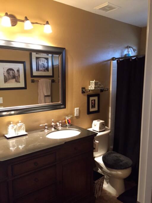 Bathroom with double sink across the hall from bedroom.