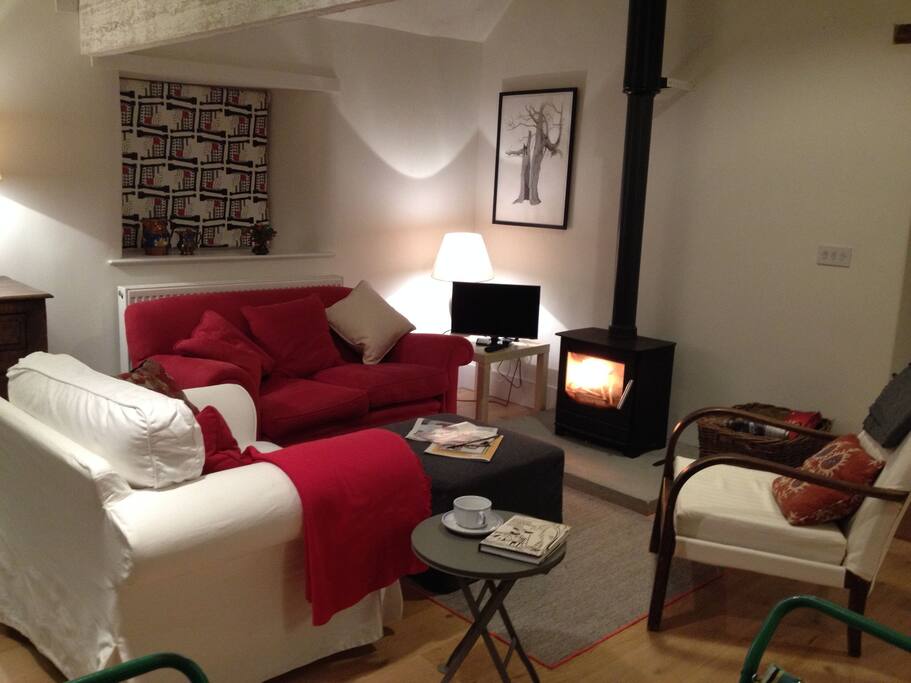 Grainstore on Winter night with glowing log burner: unlimited wood