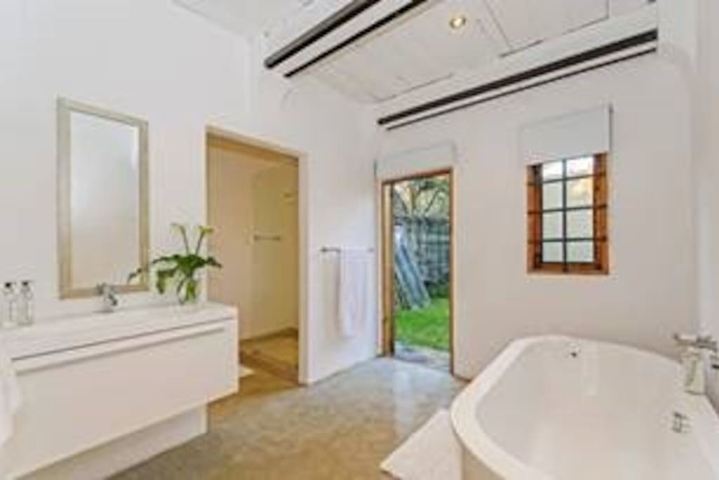 En suite bathroom with bath and shower
