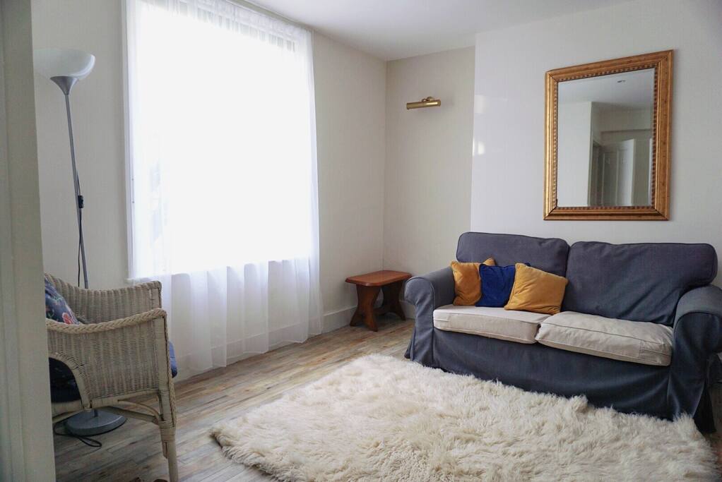 overview of living area with armchair and a nice two seat sofa