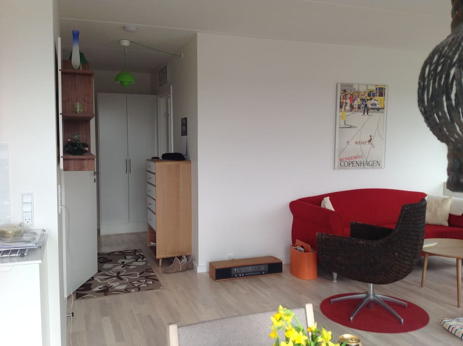 Part of the living room and entrance hall towards bedrooms.