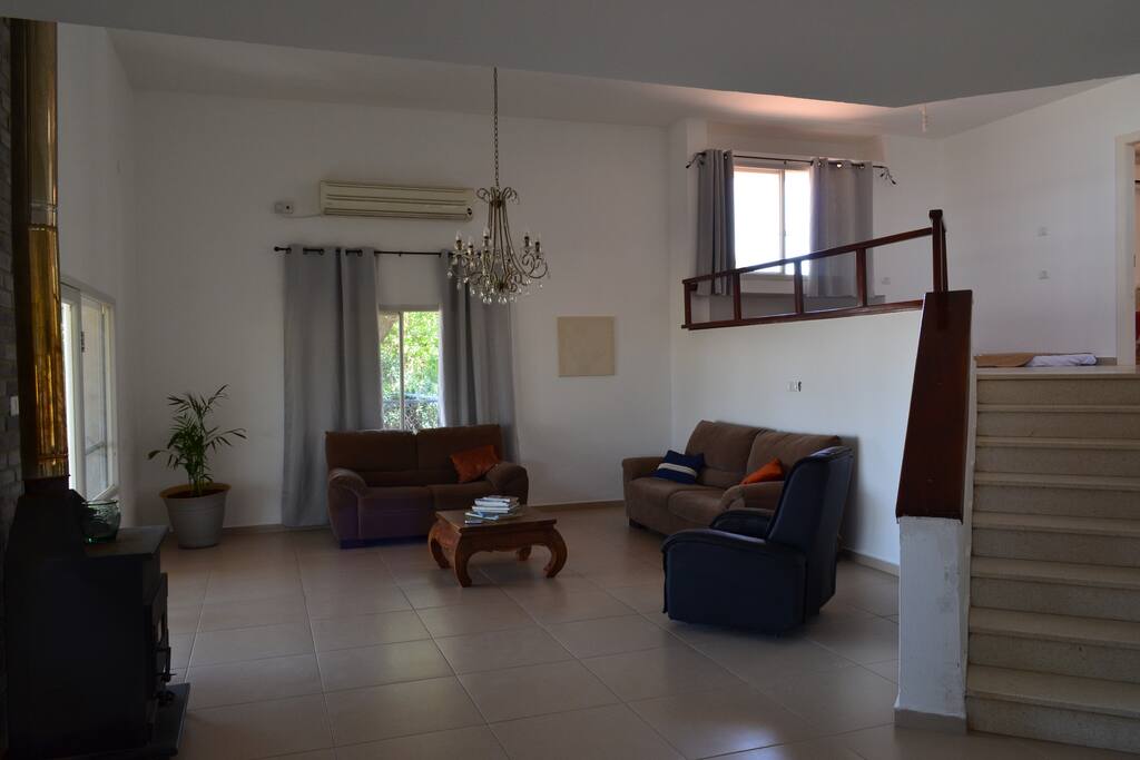 view from the dining area of the living room and stairs leading to bedrooms