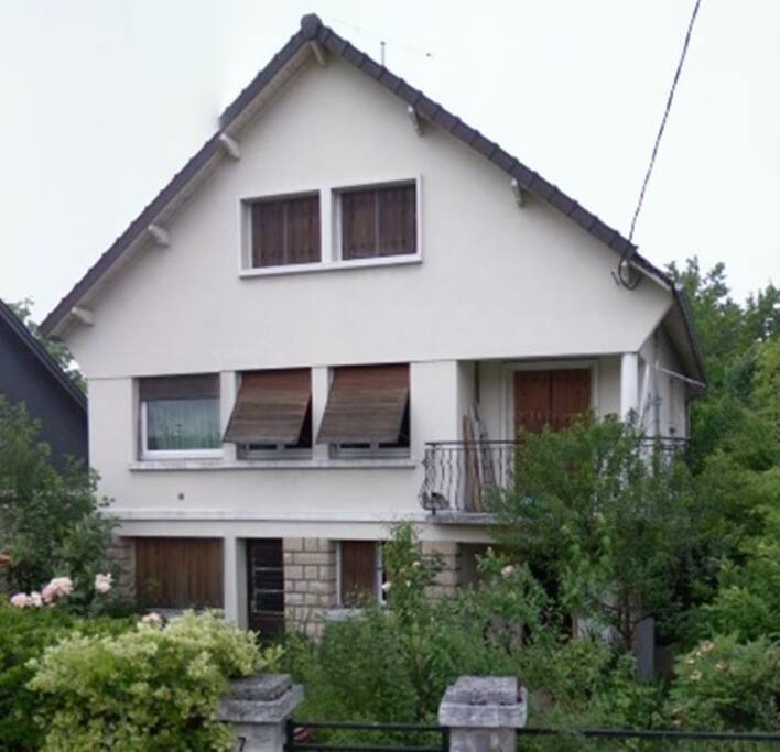 Une grande maison entourée de verdure