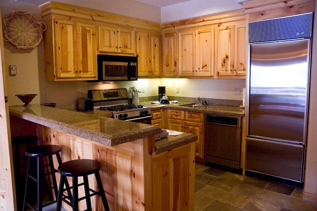 The fully-equipped kitchen has modern appliances and beautiful wood touches