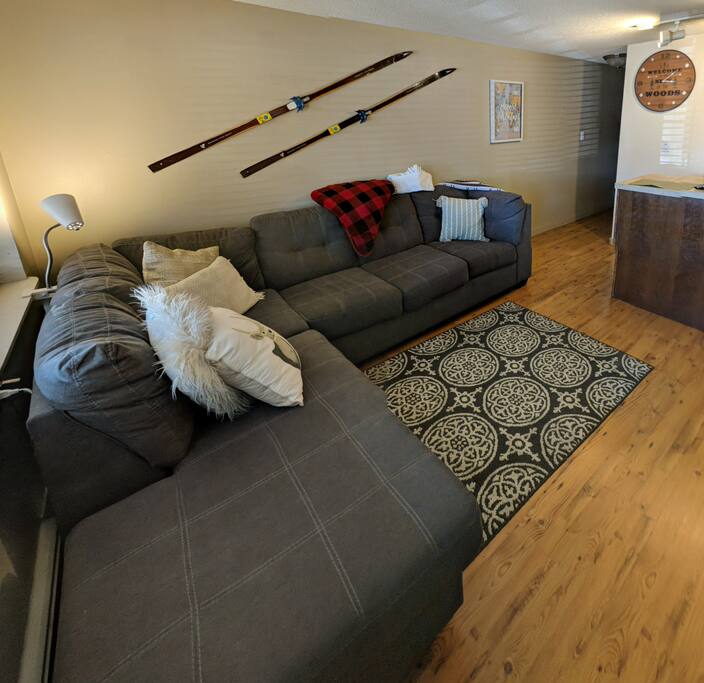 Living room with full-size sleeper sectional sofa + chaise