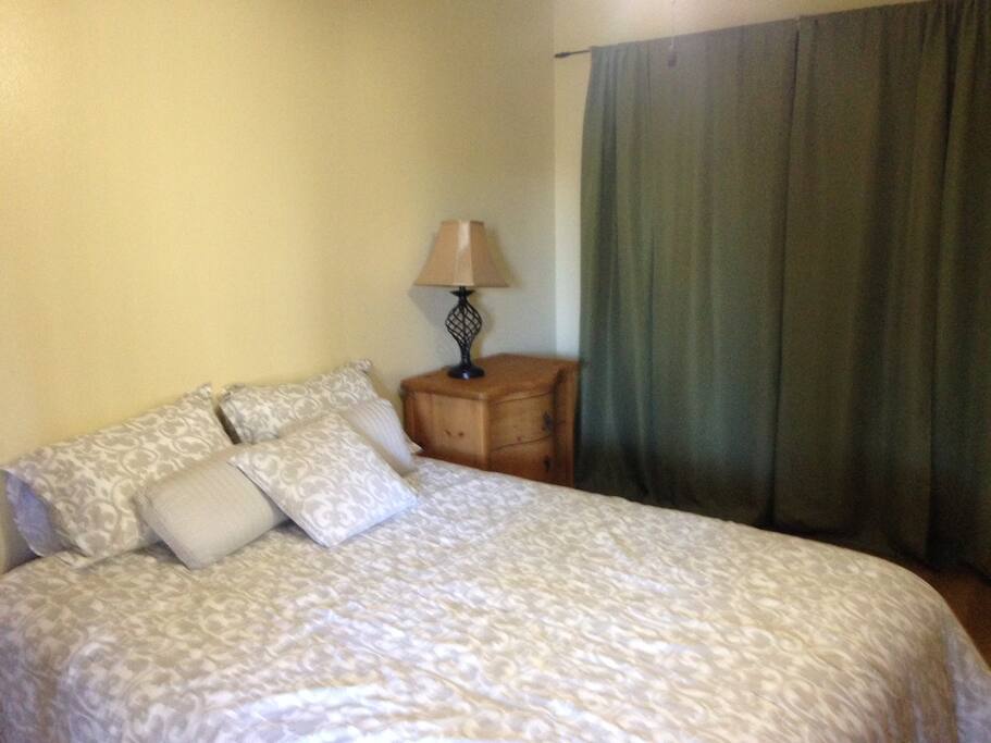 Comfortable Queen size bed and ceiling fan in the bedroom