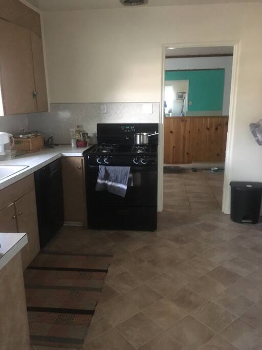 The kitchen has plenty of cooking and eating supplies.