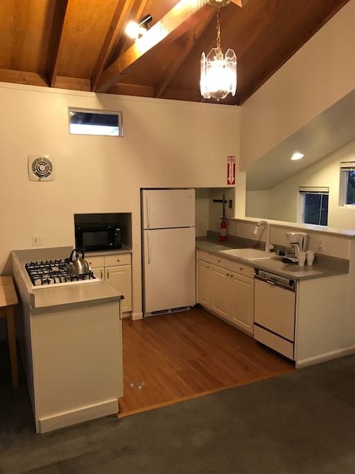 Kitchen with gas stove, microwave, fridge, dishwasher, sink. Please use that wall fan when cooking.