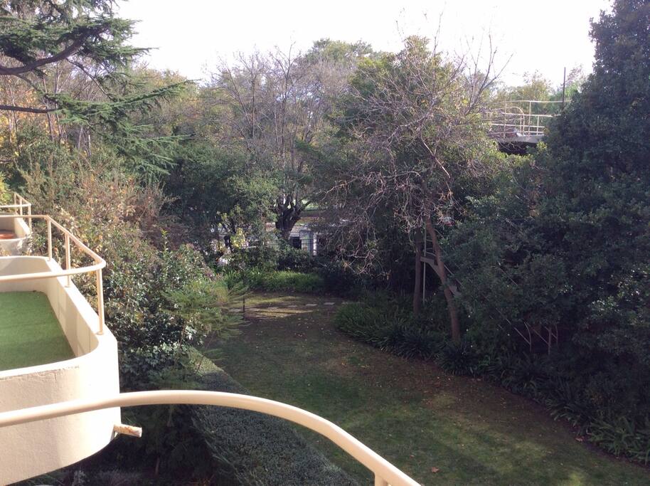 Private balcony overlooking leafy garden