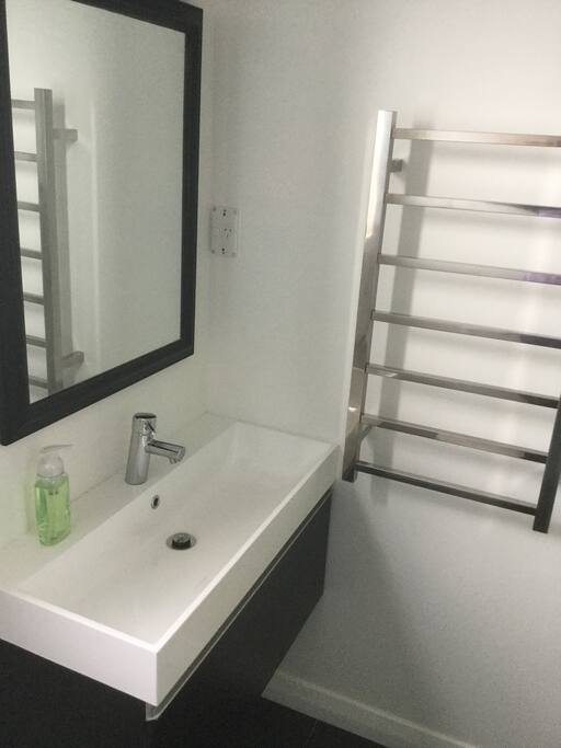 Private ensuite with heated towel rail & Grohe tap ware & showerhead