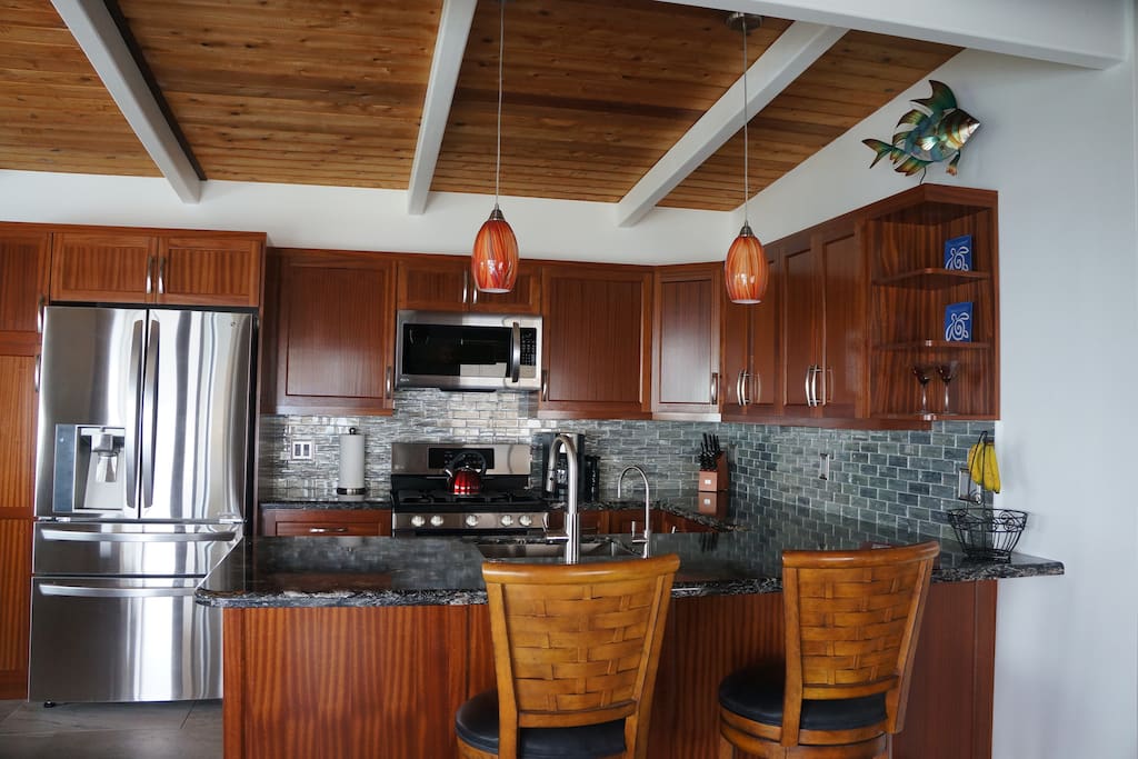 Custom gourmet kitchen with tropical mahogany cabinets