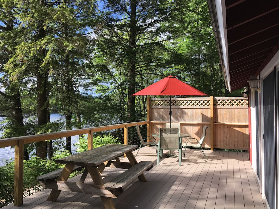 The deck runs along the entire lakeside of the cottage. Grill is at the end opposite the umbrella table.