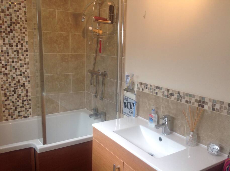 Modern bathroom with shower over the bath.