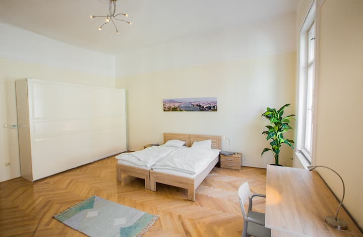 This bedroom has two single beds (pushed together on this picture), a sofa bed, a large cupboard and a desk. Large windows make the room bright but it is possible to darken it for sleeping purposes.

