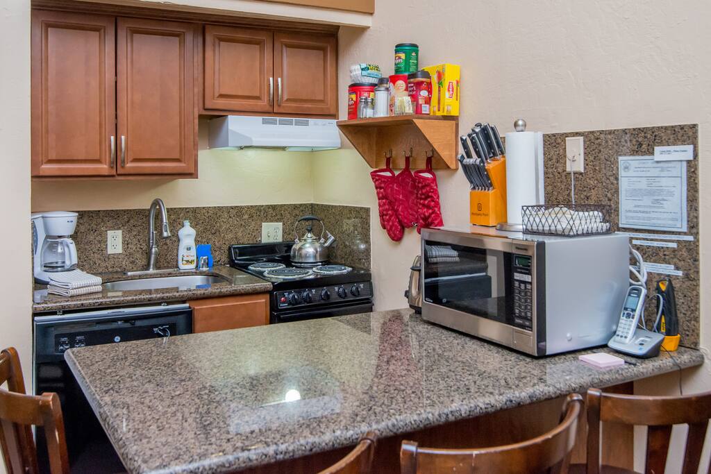 Kitchen is complete with stove-top oven, dishwasher, microwave, coffee maker, toaster and blender.