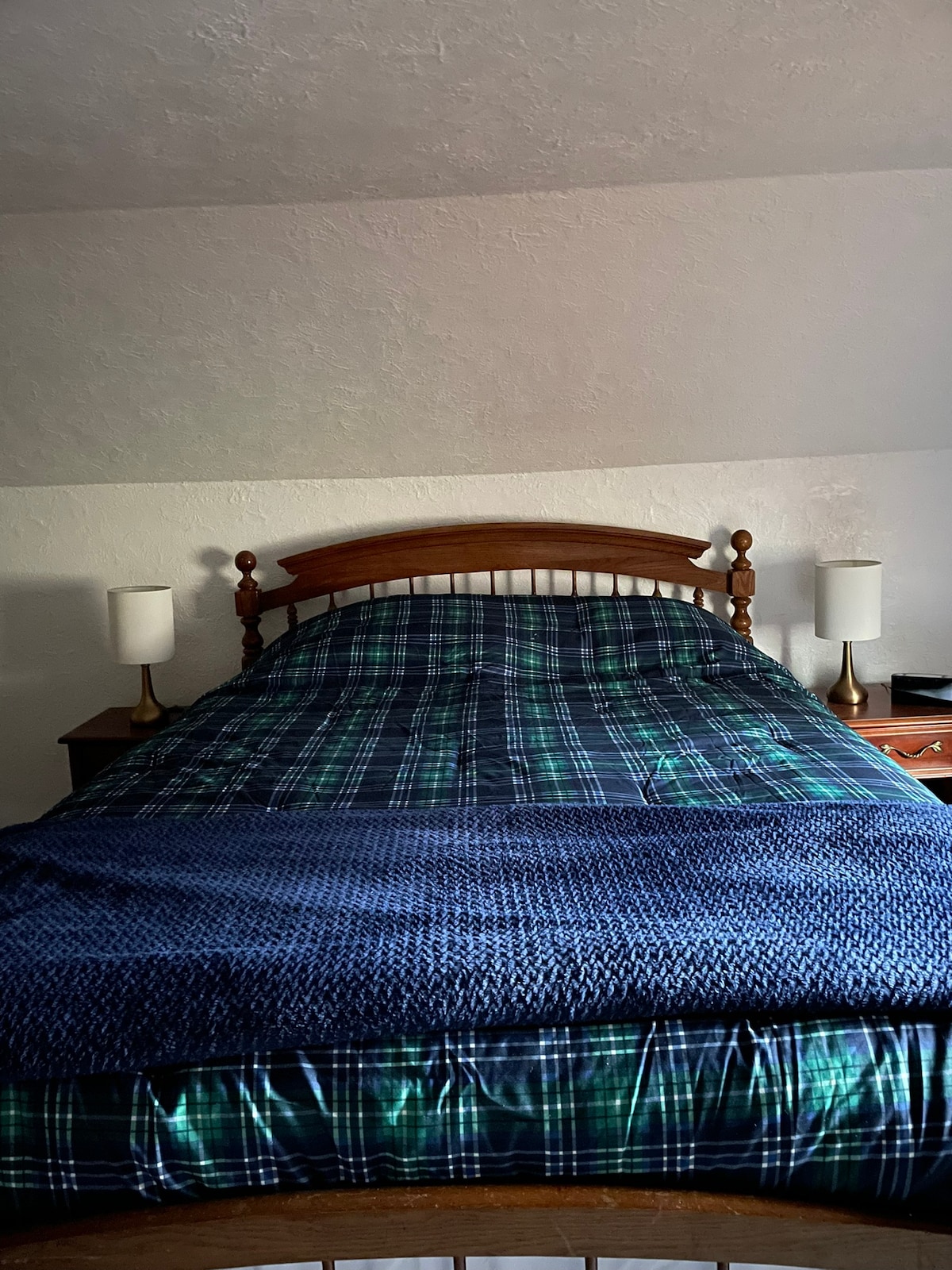 4th bedroom upstairs with a queen bed. Adjoins 3rd room with no door. 
AC window unit for summer. USB charging ports in the stand on the left. Alarm clock has USB charging port.