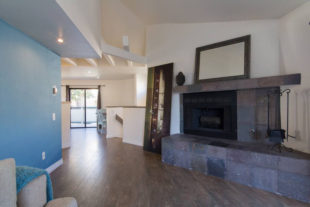 Living room leading into kitchen, dining area, and 1 of 2 outdoor patios.