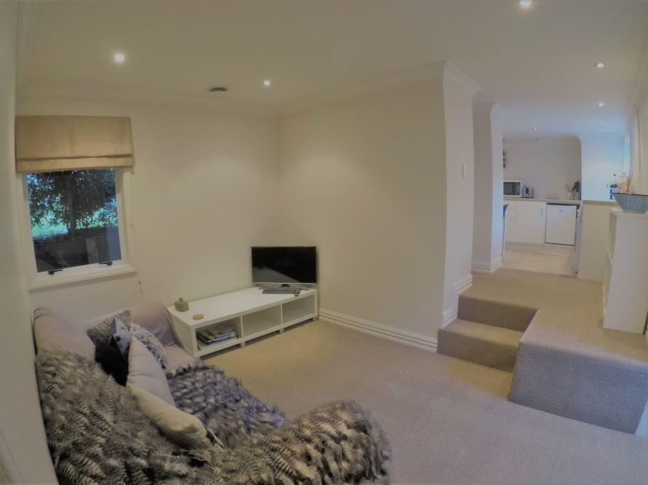 Private living area with sofa and TV.