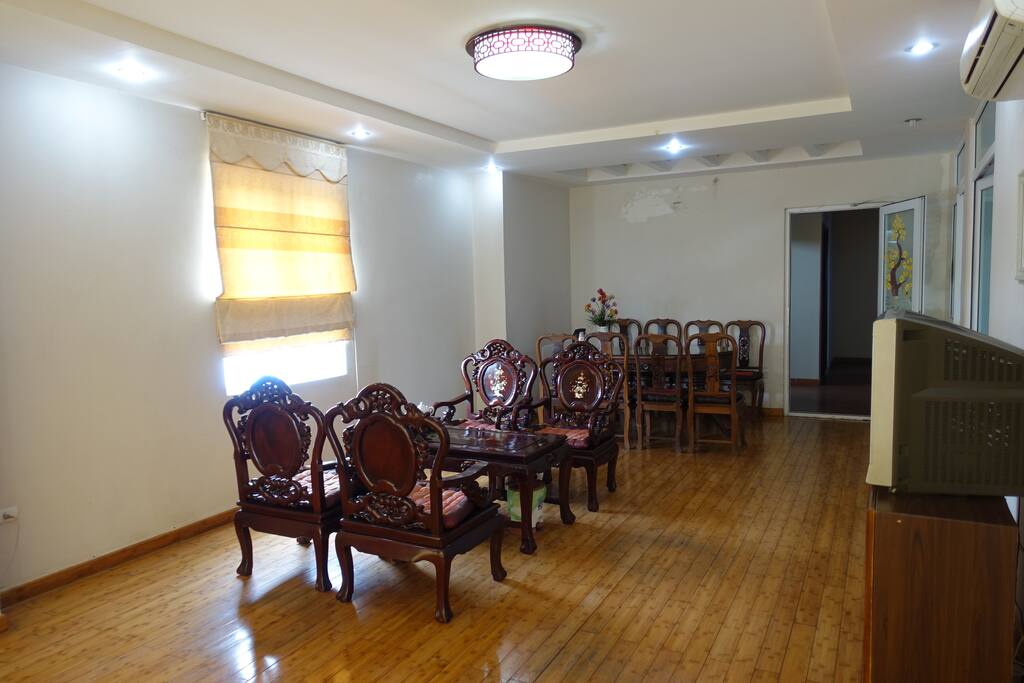 Living room - Equipped with two sets of vintage tables / chairs. A television with international channels. A medium size refridgerator.