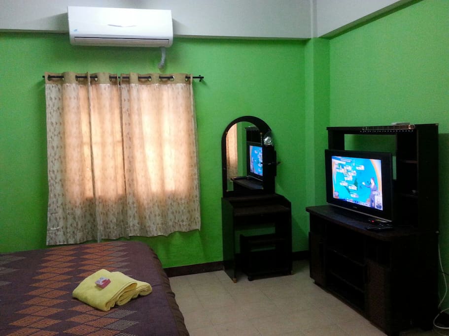 A spacious studio with a big bed, air con, flat screen TV, fridge, microwave, table & chairs