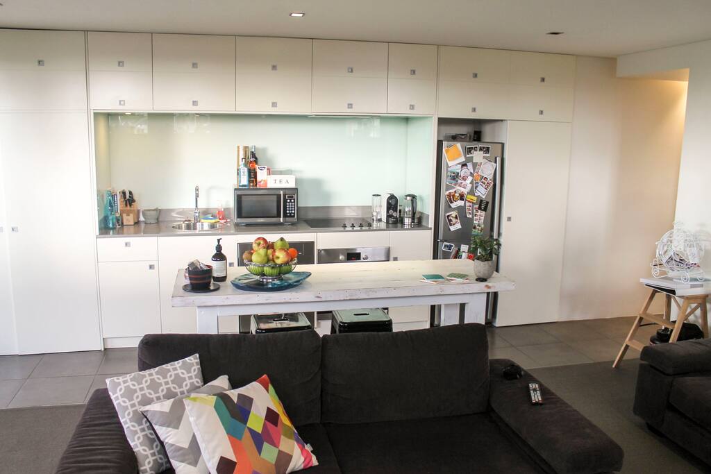 Open kitchen with microware, oven, dishwasher, fridge, full pantry, coffee machine (with pods), tea and kettle.
Laundry is hidden behind door on the left with washer, dryer, ironing board and iron.