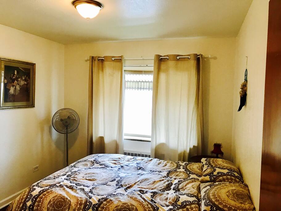 Back guest room with a queen bed pillow top mattress.