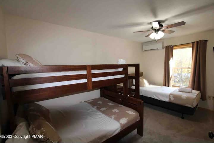 Upper level bunk room bunk bed with a twin on top & full sized bed and twin bed also. Extra crib is in the closet. 