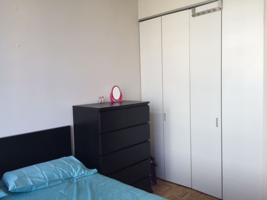 Other side of the room with a large closet and bathroom & full length mirror right next to the entrance