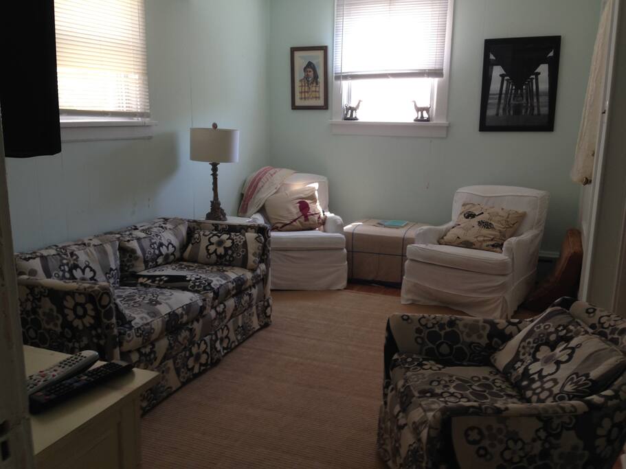 cozy tv room. Bunk room is behind first chair on right