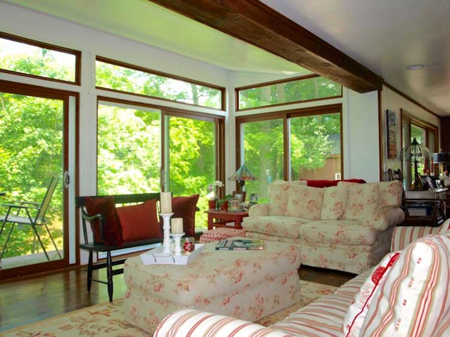 Living room with sliding glass doors to deck overlooking river.