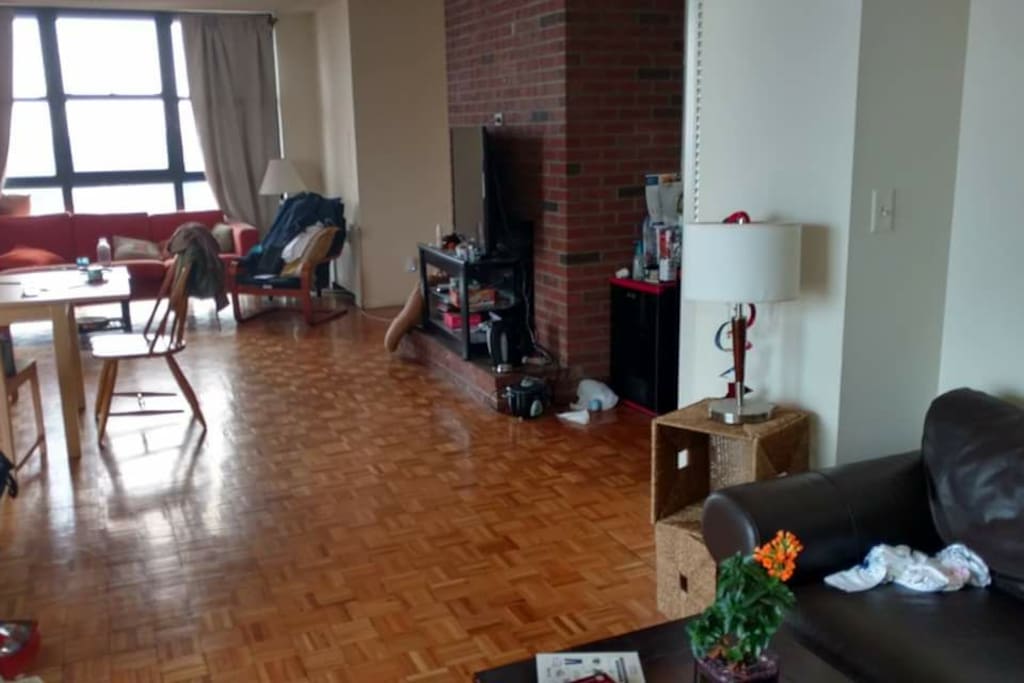 another view of the large open living space (bedroom is located behind the brick wall)