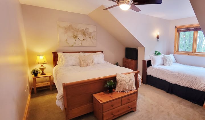 Second floor bedroom with comfortable queen bed and double bed and ceiling fan 