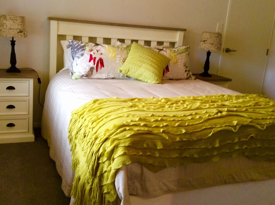 Main bedroom with comfy queen bed, chest of drawers and closet.