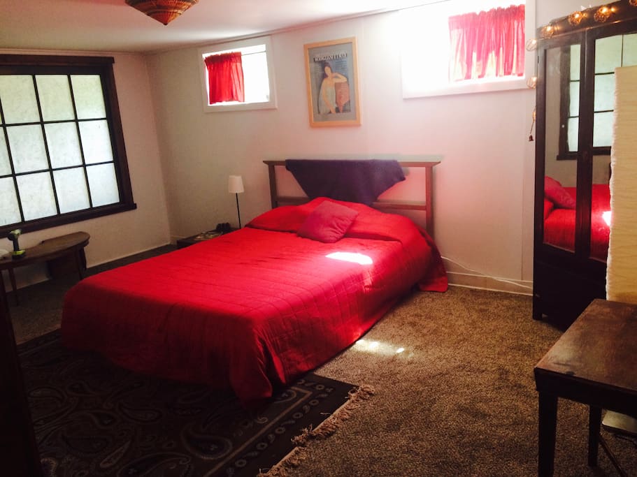 queen size bed in sleeping area & wardrobe