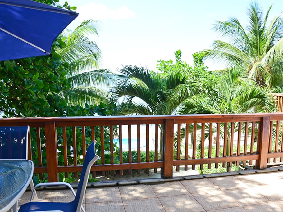 Main floor deck with bar area, loungers and shade.