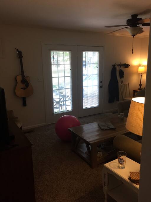 Second living area with tv and access to back patio. Large sectional sofa for relaxing!