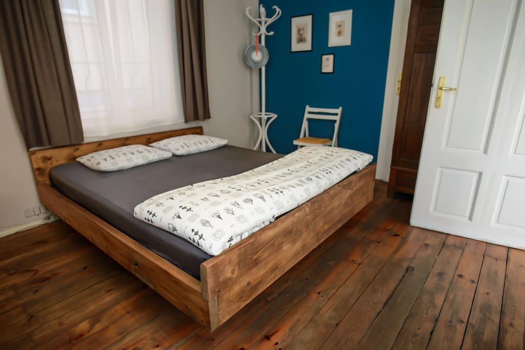 Handmade wooden bed in the Superior Double Room